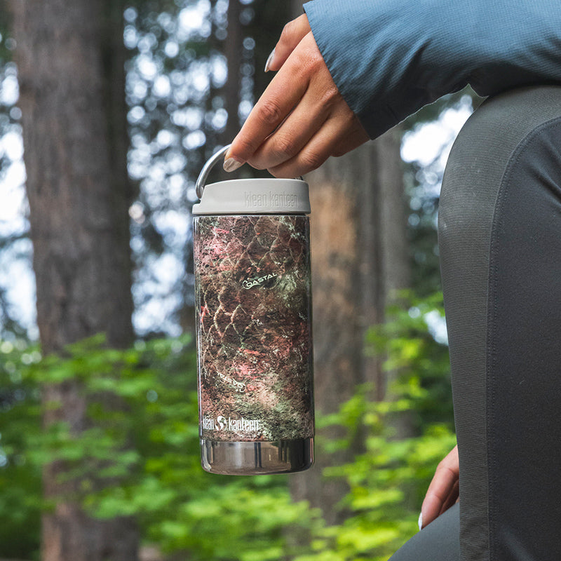 12oz-tkwide-with-cafe-cap-mossy-oak-g1 12oz_tumbler_mossyoak_rainbowtrout_hand_closeup_square.jpg