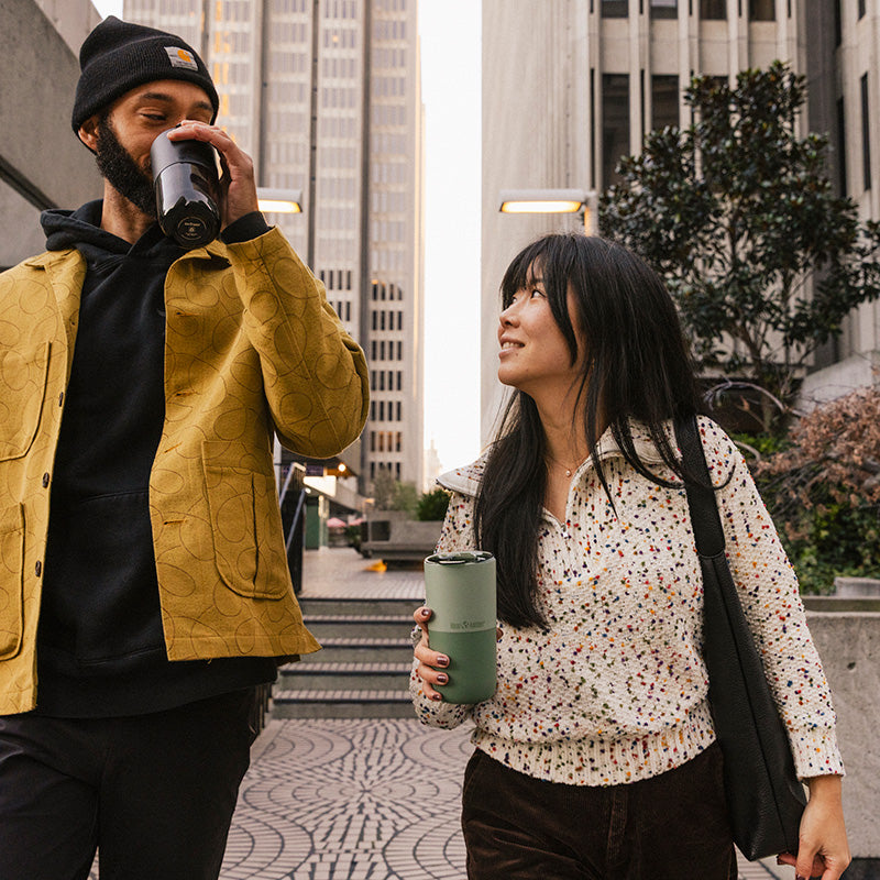 16oz-rise-tumbler-c3 16oz_rise_tumbler_black_iceberg_couple_drink_city_street_square.jpg