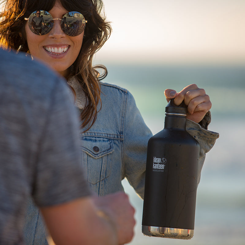 64oz-classic-with-loop-cap-w4 64oz_insulated_classic_black_beach_girl_hand_square.jpg